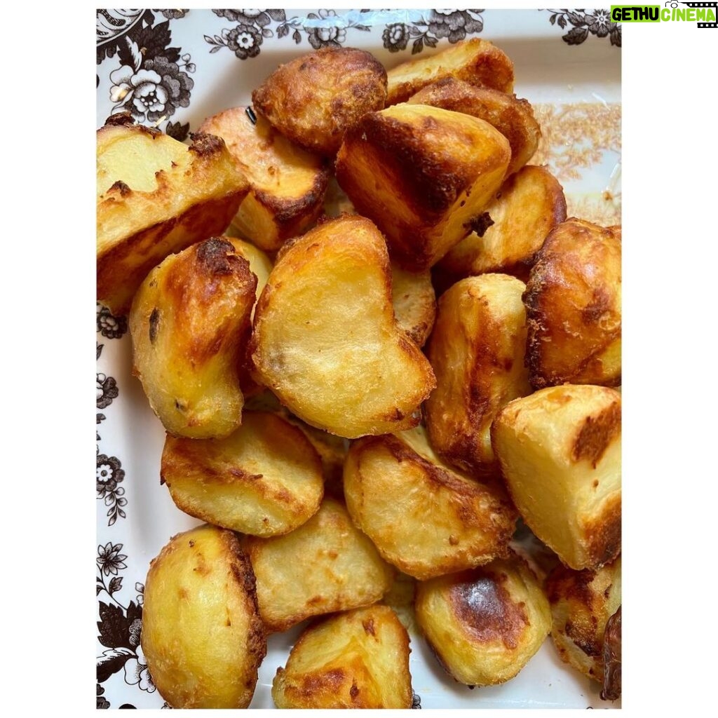 Ginnifer Goodwin Instagram - Dear @missjobaker, Here is my babbling recipe for #roastpotatoes. Slide 2. I prep my (often Yukon gold) #potatoes at least 24 hours before I want to cook them. I peel said potatoes and cut them into same-ish sized pieces. I do NOT parboil them. I generously salt the potatoes and STEAM them for as long as it takes me to drink a cup of tea, get sucked into a book, and go, “Oh no! The potatoes!” I bet this is a 15 minute experience? Then I take a skewer and rake that across a potato. Is there evidence of potato-ness on said skewer? If so, I move on to… Slide 3. Holding the lid firmly in place, I bang the potatoes about the steam basket. I then remove the lid and let the potato steam do it’s go-away thing. Slide 4. I line a baking sheet with a piece of parchment paper and spread the potatoes out so that they are not touching. I cover the whole thing in plastic wrap, because I haven’t found a better solution. I put the baking sheet in the freezer til whenever-in-the-future I need to roast potatoes. The freezer is the secret weapon. Slide 5. On another day when I’m hungry, I preheat the oven to 400F. I coat my roasting tin with a high-smoke-point oil — my fam prefers something animal-based — and I use only enough to make the whole bottom glassy and that’s IT. I stick the oily tin in the oven to warm up for 5-ish minutes. NOW I go get my potatoes out of the freezer. I put the tin on the stovetop, turn up the heat to medium (if the tin is stove-top safe) and dump the potatoes in the tin. I step back! They splatter! Can you see in the photo that I use such a small amount of oil that it’s ALMOST all soaked up by the potatoes? As quickly as possible, I flip them around with tongs in what oil is left. I pop the tin in the oven. I do not touch the potatoes again. Slide 1. I wish I could tell you how long I roast my potatoes. It could be 40 minutes? I just watch the color and I fiddle with the temperature so that they come out after everything else is ready to serve. They are effing crispy on the outside and effing fluffy on the inside. Lemme know if you give ‘em a try! P.S. I threw in a pic of my favorite platter, because… Digby.