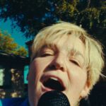Grace Baldridge Instagram – rumor rumor have you heard? heartbreak hero is out day after tomorrow ❤️‍🩹 #nationalcomingoutday #queerartist #newmusic 

🎥 @jaxanderson