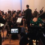 Halyna Hutchins Instagram - Another exhilarating day on set shooting a scene with 65 musicians from symphony orchestra.......................................................................#feature #filming #symphony #orchestra #music #classicalmusic #onset #onlocation #michigan #cinematography #cinematographer #arrialexamini #kowaanamorphic