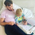 Isaac Lowe Instagram - With camp 🏕️ all done ✅ Now time to rest up 🆙 Me and me boy colouring in 💙 Rainy 🌧️ day so we haveing a chill. Day on the bed 🛌 #mybestfriend #dadslife 💙🌎