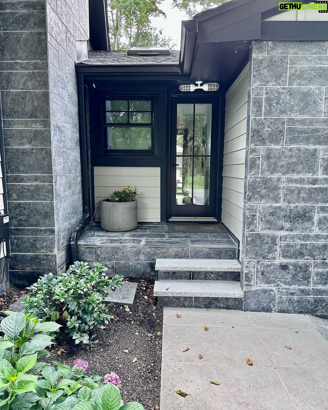 John Colaneri Instagram - #Design is all in the details and the stone work that we did around our home created a major change. When looking to update the exterior of your home always add different textures and materials. This will allow those elements to play off of each other. The earth tones from the new @jameshardie siding and the black granite from @polycor_hardscapes are two materials that work very well together. #curbappeal #exteriordesign #stoneveneer #stonework #designgoals #designinspiration #njdesigner #njbuilders