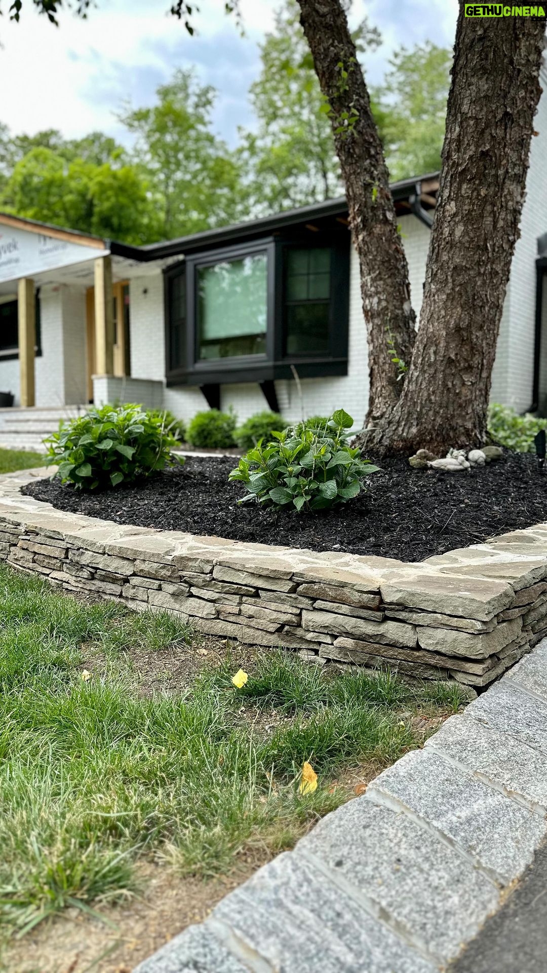 John Colaneri Instagram - Busy weekend at the #colanerihome finishing up the stone projects around the yard! Grass is starting to grow in nice and mulch is down to clean up the beds. The stone supplied from @northernvalleystone is on point and I could not be happier with choices I made. The new stacked stone walls make such a big change! Wait until I show you the landscaping lighting! Let’s get the summer projects underway! #lovetheprocess #landscape #landscapedesign #landscapedesigns #stonedesign #stonework #design #designinspiration #designgoals