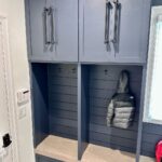 John Colaneri Instagram - My clients mudroom has been updated with custom cabinet doors and hardware. All have been painted with one of my favorites by @benjaminmoore called Mysterious AF-565 and hardware by @busterandpunch. There is a ton of storage and this color really transforms the space. The black hardware is so unique and will be a conversation starter for sure! #custommillwork #design #designinspiration #designgoals #mudroom #mudroommakeover