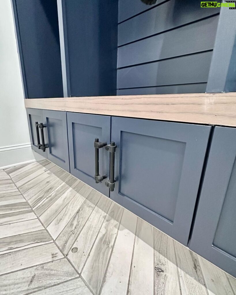 John Colaneri Instagram - My clients mudroom has been updated with custom cabinet doors and hardware. All have been painted with one of my favorites by @benjaminmoore called Mysterious AF-565 and hardware by @busterandpunch. There is a ton of storage and this color really transforms the space. The black hardware is so unique and will be a conversation starter for sure! #custommillwork #design #designinspiration #designgoals #mudroom #mudroommakeover