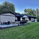 John Colaneri Instagram - A little after and before in the rear of our home. It has gone through some massive transformations over the past couple of years. I have not shared any pictures of the rear complete yet. With the new @jameshardie siding and patio by @polycor_hardscapes it is a great place to entertain and just relax. We now have around 2,000 sq ft of patio space which makes a huge difference to the property. With summer ending the fall is my favorite season by far and I cannot wait to sit around the fire 🔥 pit. @woodhavenlumber @northernvalleystone #design #designinspiration #curbappeal #exteriordesign #exteriordecor #designgoals #njdesigner