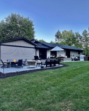 John Colaneri Instagram - A little after and before in the rear of our home. It has gone through some massive transformations over the past couple of years. I have not shared any pictures of the rear complete yet.  With the new @jameshardie siding and patio by @polycor_hardscapes it is a great place to entertain and just relax. We now have around 2,000 sq ft of patio space which makes a huge difference to the property.  With summer ending the fall is my favorite season by far and I cannot wait to sit around the fire 🔥 pit.

@woodhavenlumber @northernvalleystone 

#design #designinspiration #curbappeal #exteriordesign #exteriordecor #designgoals #njdesigner