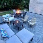 John Colaneri Instagram - Our new patio with @polycor_hardscapes is complete and now we have the dedicated fire pit area that we have always wanted! The XL pavers in the Saint Henry black granite are a statement piece for the backyard. When you have fewer joints the area looks even bigger and much more streamlined. Material supplied by @northernvalleystone #outdoorliving #polycorhardscapes #hardscapes #patiodesign #designgoals