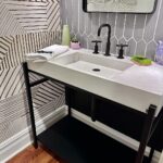 John Colaneri Instagram - A little before and after of my clients powder room! Such a small space can pack a ton of design! It is all in the details when curating a space. #bathroomdesign #bathroomdecor #bathroomremodel #bathroominspiration #bathroomideas #bathroomrenovation Sink and vanity by @trueform_concrete Faucet by @kohler Wallpaper by @thatcher.studio Lighting by @busterandpunch Mirror by @schoolhouse Tile by @tilebar