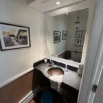 John Colaneri Instagram - A little before and after of my clients powder room! Such a small space can pack a ton of design! It is all in the details when curating a space. #bathroomdesign #bathroomdecor #bathroomremodel #bathroominspiration #bathroomideas #bathroomrenovation Sink and vanity by @trueform_concrete Faucet by @kohler Wallpaper by @thatcher.studio Lighting by @busterandpunch Mirror by @schoolhouse Tile by @tilebar