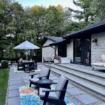 John Colaneri Instagram - A little after and before in the rear of our home. It has gone through some massive transformations over the past couple of years. I have not shared any pictures of the rear complete yet. With the new @jameshardie siding and patio by @polycor_hardscapes it is a great place to entertain and just relax. We now have around 2,000 sq ft of patio space which makes a huge difference to the property. With summer ending the fall is my favorite season by far and I cannot wait to sit around the fire 🔥 pit. @woodhavenlumber @northernvalleystone #design #designinspiration #curbappeal #exteriordesign #exteriordecor #designgoals #njdesigner
