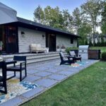 John Colaneri Instagram - A little after and before in the rear of our home. It has gone through some massive transformations over the past couple of years. I have not shared any pictures of the rear complete yet. With the new @jameshardie siding and patio by @polycor_hardscapes it is a great place to entertain and just relax. We now have around 2,000 sq ft of patio space which makes a huge difference to the property. With summer ending the fall is my favorite season by far and I cannot wait to sit around the fire 🔥 pit. @woodhavenlumber @northernvalleystone #design #designinspiration #curbappeal #exteriordesign #exteriordecor #designgoals #njdesigner