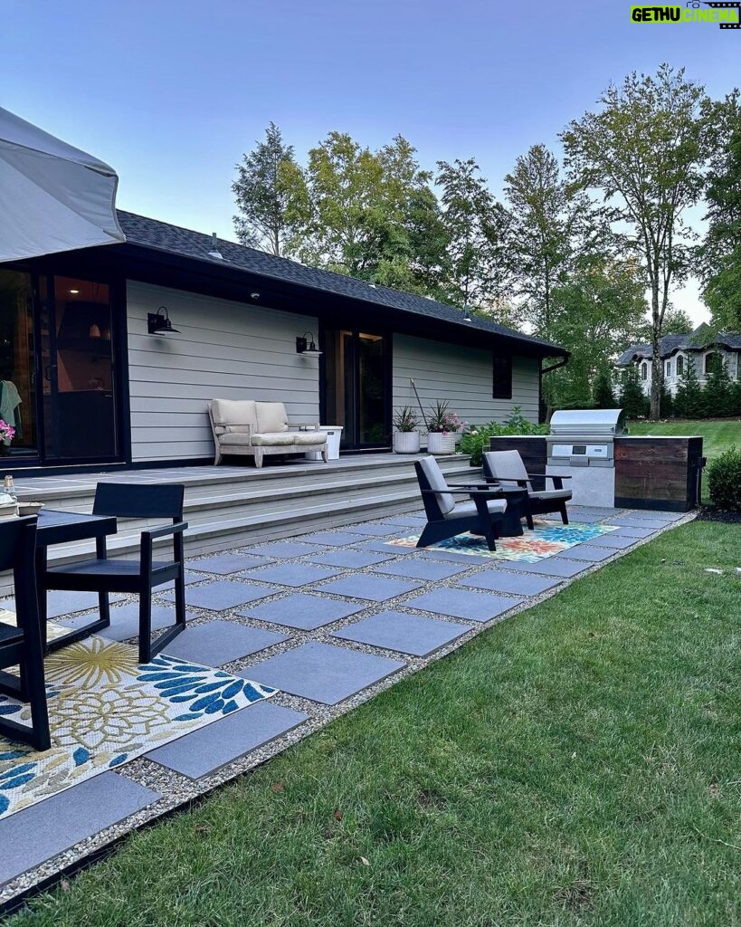 John Colaneri Instagram - A little after and before in the rear of our home. It has gone through some massive transformations over the past couple of years. I have not shared any pictures of the rear complete yet. With the new @jameshardie siding and patio by @polycor_hardscapes it is a great place to entertain and just relax. We now have around 2,000 sq ft of patio space which makes a huge difference to the property. With summer ending the fall is my favorite season by far and I cannot wait to sit around the fire 🔥 pit. @woodhavenlumber @northernvalleystone #design #designinspiration #curbappeal #exteriordesign #exteriordecor #designgoals #njdesigner