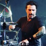 John Dolmayan Instagram – We met for the first time during Ozzfest 99 ( my personal favorite of the 4 times we were on Ozzfest) . Zombie was co headlining and system was opening the main stage (1pm) , usually playing to 1500 people and a mostly empty first 70 rows. We had met so many inspiring musicians in 98/99 and @johntempesta was one of them. Almost immediately we became lifelong friends and John would allow me to watch from behind his kit as he played his set nearly every night. Not only is he a phenomenal drummer and incredibly versatile (playing almost any style he wants )but John is a humble and open person. I’ve never seen him even slightly upset , he always has a smile on his face and an excitement to play and his attitude is infectious. Like any family member, anytime we see each other we pick up exactly where we left off. I remember vividly that both of our kits were set up next to each other backstage at Ozzfest 2002 . We happened to be together and were checking our kits to make sure everything was in order when we spontaneously went into a double drummer drum solo . We went back and forth , trying to escalate the technique and feel of our solos using each others talent as inspiration to out do each other on the next phrasing . Before we knew it there were a hundred or so techs , guests , and security watching the impromptu show behind the show happening 100feet away. I wish my friend Mike ( he taped it ) wasn’t such a damn stoner and lost the tape! Drummers like John make me want to be a better drummer and are the fuel for learning and improving. I’ve learned much from him over the years both in being a better drummer and a better human being . Recently Dave , John , and I went to dinner and it was such a fun time . Reminiscing and laughing , friends enjoying life. I can’t believe I get to hang out with the drummers who inspired me in my formative years and who continue to do so today ! I hope there are kids out there who are equally inspired by what I do , one day the baton will pass from us to you and so on and so on .