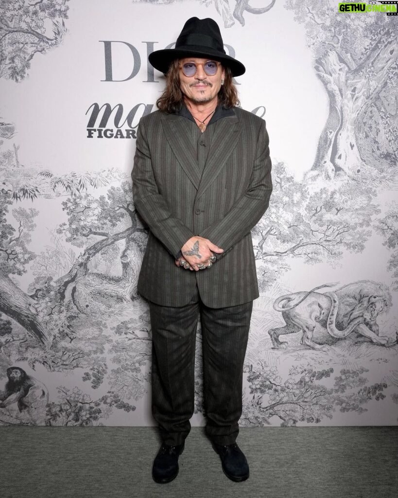 Johnny Depp Instagram - Staying true to his inimitable sense of style, it's been a week of Dior men's hits for @JohnnyDepp at the @FestivaldeCannes 2023. The Ambassador of the Dior Sauvage fragrance joined the cast of "Jeanne du Barry" on the red carpet in a sharp and elegant custom double-breasted tuxedo, wing-tip collar plastron shirt with jewellery buttons and silk pocket square by @MrKimJones. For the film's press conference, the actor donned a grey wool peak-lapel suit with matching vest and black leather boots, while at the Dior x @MadameFigaroFR x @MoetChandon dinner he rocked a chic, striped three-piece suit by the House. Swipe to see the outfits and the #DiorSavoirFaire behind his opening ceremony look.  #StarsinDior #DiorCannes
