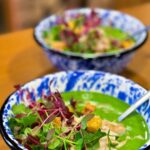 Kamila Rundusová Instagram - Pea soup with mint and coconut milk (ČJ👇) 2x 400g packs of frozen peas 2x 400g can of coconut milk 5 cloves of garlic 1 medium white onion 12 mint leaves 2 tablespoons of olive oil 4 tablespoons nutritional yeast (optional) salt and lemon juice to taste pinch of nutmeg + broth or water TIP: I use frozen peas that are pre-steamed, so I don’t cook them any further and thanks to this, the soup retains green color. 1. Let the frozen peas defrost. 2. Chop the onion. 3. Heat a saucepan, add oil, onion and cloves of garlic. Fry for 1 minute, then pour in 1 ladel of broth (or water), cover with lid and cook for until the garlic is soft. 4. Into a blender add 1 pack of thawed peas, 1 coconut milk, 1/2 of the contents in the pot with onion and garlic, 6 mint leaves, nutmeg, 1 ladleful of stock or water. Blend everything. Transfer to a larger pot. 5. Repeat the same with the other half of the ingredients. 6. Heat the soup to only warm the soup. Add salt to taste, add nutritional yeast (if you like) and add lemon juice. ČESKY: Hrášková polévka s mátou a kokosovým mlékem 2x 400g balení mraženého hrášku 2x 400g plechovka kokosového mléka 5 stroužků česneku 1 střední bílá cibule 12 lístků máty 2 lžíce olivového oleje 4 lžíce lahůdkového droždí (libovolné) sůl a citrónová šťáva na dochucení špetka muškátového oříšku + vývar nebo voda na rozředění TIP: Používám mražený hrášek, který je předem připravený na páře, takže ho pak dál nevařím a díky tomu si polévka uchová barvu. 1. Mražený hrášek nechám povolit. 2. Cibuli nasekám nahrubo. 3. Hrnec rozpálím na středním plameni, přidám olej, cibuli a celé stroužky česneku. Opeču 1 minutu, podleji sběračkou vývaru (nebo vody), přiklopím, stáhnu plamen a vařím, dokud není česnek měkký. 4. Do mixéru dám 1 balení rozmraženého hrášku, 1 koko mléko pokojové teploty. 1/2 obsahu hrnce s cibulí a česnekem, 6 listů máty, muškátový oříšek, 1 sběračku vývaru nebo vody a vše rozmixuju do krémové směsi. Přendám do většího hrnce. 5. To samé zopakuji s druhou polovinou surovin. 6. Obsah hrnce jen ohřeju (nevařím). Dle chuti dosolím, přidám lahůdkové droždí a dokyselím citrónem.