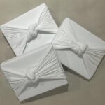Kim Kardashian Instagram – Wrapping gifts in our family is always such a fun family tradition to see what each family member did and their vibe for the year. Each represents us so well! 
I did all white SKIMS cotton jersey t shirt fabric. I’m excited to reuse it and make other things.
Kylie did a festive Santa print.
Kravis a simple green cool wrapping. 
My mom a shiny metallic red wrapping. 
Kendall did a chic blue and white print with green bow. 
Rob wrapped everything in a festive snowman print with a white bin that has these soft ball shape.
Khloe did a gorgeous monochromatic green with green ribbon.