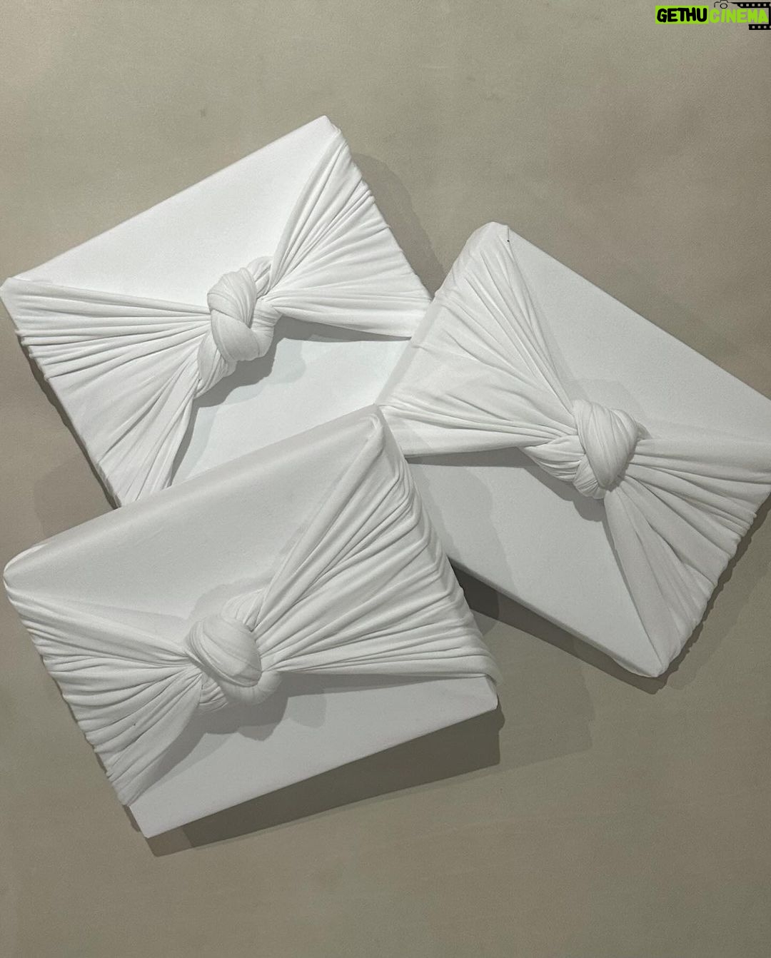 Kim Kardashian Instagram - Wrapping gifts in our family is always such a fun family tradition to see what each family member did and their vibe for the year. Each represents us so well! I did all white SKIMS cotton jersey t shirt fabric. I’m excited to reuse it and make other things. Kylie did a festive Santa print. Kravis a simple green cool wrapping. My mom a shiny metallic red wrapping. Kendall did a chic blue and white print with green bow. Rob wrapped everything in a festive snowman print with a white bin that has these soft ball shape. Khloe did a gorgeous monochromatic green with green ribbon.