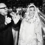 Kourtney Kardashian Barker Instagram - One year ago, we had our first in-person meeting with @dolcegabbana to start the design process of my wedding dress!! The first inspiration for my dress was when Travis and I were watching Guns N’ Roses November Rain video one night before we were even engaged, and we said to each other “this has to be our wedding.” She was wearing a short dress and I thought to myself “I need a short dress!” I had more visions inspired by some 1990s campaigns of Monica Bellucci shot by Helmut Newton for Blumarine. When we knew our wedding was going to be in Portofino, it also influenced the vibes and feeling of the dress. I also just wanted to feel like we ran off to Italy and got married and wanted the dress and wedding to feel that way! When @dolcegabbana suggested putting Travis’s head tattoo of the Virgin Mary on the handmade lace veil with the words from his tattoo: family, loyalty, respect underneath, I got chills and knew how special that felt. (And my little mini veil I wore to dinner ☺️) This was all planned and made into my dream come true all so so quickly and I’m so grateful to everyone who put their all into making it all happen! ✨🫶🏼❤️