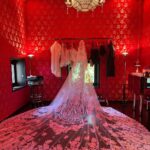 Kourtney Kardashian Barker Instagram - One year ago, we had our first in-person meeting with @dolcegabbana to start the design process of my wedding dress!! The first inspiration for my dress was when Travis and I were watching Guns N’ Roses November Rain video one night before we were even engaged, and we said to each other “this has to be our wedding.” She was wearing a short dress and I thought to myself “I need a short dress!” I had more visions inspired by some 1990s campaigns of Monica Bellucci shot by Helmut Newton for Blumarine. When we knew our wedding was going to be in Portofino, it also influenced the vibes and feeling of the dress. I also just wanted to feel like we ran off to Italy and got married and wanted the dress and wedding to feel that way! When @dolcegabbana suggested putting Travis’s head tattoo of the Virgin Mary on the handmade lace veil with the words from his tattoo: family, loyalty, respect underneath, I got chills and knew how special that felt. (And my little mini veil I wore to dinner ☺️) This was all planned and made into my dream come true all so so quickly and I’m so grateful to everyone who put their all into making it all happen! ✨🫶🏼❤️