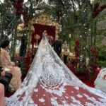 Kourtney Kardashian Barker Instagram - One year ago, we had our first in-person meeting with @dolcegabbana to start the design process of my wedding dress!! The first inspiration for my dress was when Travis and I were watching Guns N’ Roses November Rain video one night before we were even engaged, and we said to each other “this has to be our wedding.” She was wearing a short dress and I thought to myself “I need a short dress!” I had more visions inspired by some 1990s campaigns of Monica Bellucci shot by Helmut Newton for Blumarine. When we knew our wedding was going to be in Portofino, it also influenced the vibes and feeling of the dress. I also just wanted to feel like we ran off to Italy and got married and wanted the dress and wedding to feel that way! When @dolcegabbana suggested putting Travis’s head tattoo of the Virgin Mary on the handmade lace veil with the words from his tattoo: family, loyalty, respect underneath, I got chills and knew how special that felt. (And my little mini veil I wore to dinner ☺️) This was all planned and made into my dream come true all so so quickly and I’m so grateful to everyone who put their all into making it all happen! ✨🫶🏼❤️