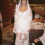 Kourtney Kardashian Barker Instagram - One year ago, we had our first in-person meeting with @dolcegabbana to start the design process of my wedding dress!! The first inspiration for my dress was when Travis and I were watching Guns N’ Roses November Rain video one night before we were even engaged, and we said to each other “this has to be our wedding.” She was wearing a short dress and I thought to myself “I need a short dress!” I had more visions inspired by some 1990s campaigns of Monica Bellucci shot by Helmut Newton for Blumarine. When we knew our wedding was going to be in Portofino, it also influenced the vibes and feeling of the dress. I also just wanted to feel like we ran off to Italy and got married and wanted the dress and wedding to feel that way! When @dolcegabbana suggested putting Travis’s head tattoo of the Virgin Mary on the handmade lace veil with the words from his tattoo: family, loyalty, respect underneath, I got chills and knew how special that felt. (And my little mini veil I wore to dinner ☺️) This was all planned and made into my dream come true all so so quickly and I’m so grateful to everyone who put their all into making it all happen! ✨🫶🏼❤️