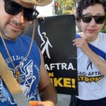 Kristen Schaal Instagram – This is my costume since July. #sagaftrastrong sending love and support. The majority of actors don’t have big breaks early on. They have day jobs and night jobs. They ask their buddies to cover their section while they dip out to audition. They realize the lunch shift isn’t going to pay the bills and the night shift isn’t going to allow them to do comedy shows (mostly unpaid). So they take a temp job and ask their buddies to cover for them if their audition during lunch goes long. Getting an audition is the hardest part, getting an agent is almost impossible, and getting the actual job is based on whatever vibe the director is feeling even if on paper you are more than qualified. So. By the time you join SAG-AFTRA it is earned. I’m proud to be a part of this union and support all actors at every point in this long game. And congratulations to the #UAW! This feels like the movement this country has been waiting for.