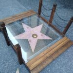 Kristen Schaal Instagram - Today I donated the first ever @hwdwalkoffame Foot Bridge at Andy Kaufman’s ceremony. My hope is that no one’s dirty feet, dog shit, bird shit, or gum will ever touch his precious star that took 40 years after his death to get. I also donated a rug to go over the bridge to keep it clean too. Thank you to Arturo Guzman and his friend for building it, Rich Blomquist for the rug idea (zoom in on rug), the Kaufman’s for letting me be a part of this historical event, and to Andy for the inspiration.