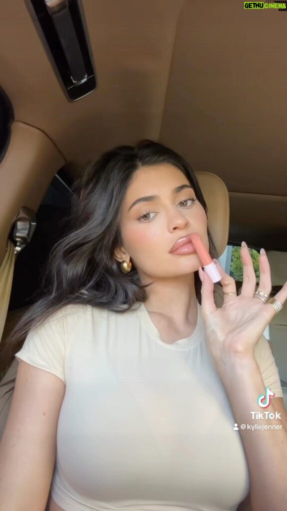 Kylie Jenner Instagram - in love with my tinted butter balms 🫶🏻 wearing shade ‘Love That 4 U’ sooo hydrating and buttery smooth. available now KylieCosmetics.com @kyliecosmetics