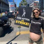 Lilan Bowden Instagram - #SAGAFTRA ON STRIKE 🪧 Thought I was having a baby sooner but he refuses to come out until the AMPTP comes to the table with a fair deal. SAG-AFTRA joins the WGA on the picket line as greedy studios refuse to negotiate FAIR PAY for the entertainers who make them their money. As a working actor, I have seen and felt personally how increasingly difficult it becomes year after year to make a living at what we do. A big part of this is how few streaming residuals are shared with the artists. The projects I have been most recognized for are not necessarily the ones that I have made the most money on. There is an ever present myth that if you can be recognized on TV, you must be rich. With the way payment models are now, that can’t be farther from the truth. Some actors are able to find financial success, and some, even if they are on hit shows, still barely struggle to get by. Without negotiating a new deal, a fair deal, it will become virtually impossible to make a living as an actor. Another thing we’re fighting for is protection against AI. Right now the AMPTP wants to pay background actors for ONE DAY of work and then use their image as much as they like in perpetuity (FOREVER). This is absolutely rotten!! I stand in solidarity with my union and the WGA for FAIR PAY and FAIR PROTECTIONS so acting can continue to be a viable career!! #sagaftrastrong #1u