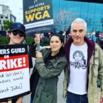 Lilan Bowden Instagram - Andi Mack reunion out here on the picket line! @thelukemullen and @oliver_vaquer and I stand in solidarity with the WGA ✊🏼 Fair wages for writers!! Writers are asking for a mere 2% of unprecedented studio profits to be shared so being a TV writer can remain a career and not a gig like it has turned into for so many. Writers deserve to make enough to get health insurance, and to get paid fairly for the work they create, especially when studios and CEOs are making more money than ever before off of streaming. The same issues affect actors, which is one reason why @sagaftra supports @writersguildwest . And yes, @asianafshow fans, Oliver IS sporting our iconic call-to-action shirt #stayangry #wgastrong