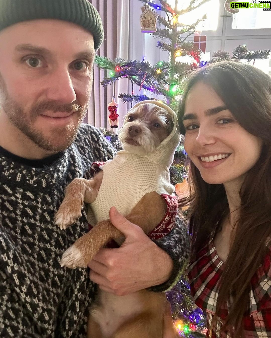 Lily Collins Instagram - The process of getting our holiday photo involves lots of @redforddog kisses (plus a cute cozy sweater) and we’re not complaining. Merry Christmas, everyone! From our lil family to yours…