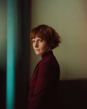 Louise Brealey Instagram - My new headshot. In it I also have shoulders and indeed some of a torso. I love @philsharp. He is basically the best; he paints photos like a Dutch master. This is in loving memory of my burgundy jumper which has since been gobbled by tineola bisselliella, the jumper-munching little fucks. Look at my great hair. Here I am also seen honouring my boyfriend’s team, Aston Villa. #utv #headshot #headandshouldersshot #castmeinsomethingwhileihavegreathairfortheloveofgod