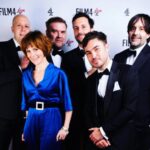 Louise Brealey Instagram – So proud of our little film. To see Brian and Charles dancing in the kitchen on the giant screen with Cate Blanchett, Viola Davis, Michelle Yeoh and Julianne Moore in the house eating chocolate BAFTA faces well that was magic.
I have a lot of people to say thank you to who made me look presentable on the red carpet. Prepare for hyperbole. It takes an army.
First. My friend and Pygmalion @mary_fellowes who spends her life now working tirelessly to make fashion more sustainable and less hideously polluting. She lent me my heavenly blue vintage velvet and assembled the crack team tasked with my transformation. Without her I would be just posting a picture of my dessert.
Hair by amazing @gillsondavid at @issysbelgravia – he is quite frankly a magician. Thank you SO much, David!
I can’t stop stroking my nails thanks to Joan (@nails.issys) they are like beautiful seashells on the ends of my funny sparrow claws.
Stylists! Magazines! Publicists! Use South African maestro @lesleywhitbymakeup – who has just decamped to London – for everything.
A massive thank-you to antique jewellers @susannahlovisjewellers who have a shop in Burlington Arcade and who trusted me with unbelievable shiny things. A gold and diamond panther bracelet from 1980 I called John. A Cartier claw ring and a star burst of diamonds in my ears. Thanks to them I thrust the panther in everyone’s face all night and no one thought I was weird.
Right I’d better get these fake eyelashes off. Happy Monday, Kids. Royal Festival Hall