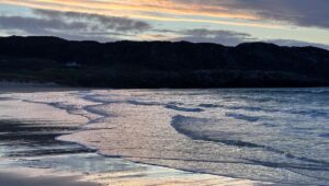 Louise Brealey Instagram - We drove west along the north coast of Scotland into the dazzle of a sunset and made it to the beach just before the sun slipped down behind a band of cloud. 

There was a smushed marigold on the tide line. I walked the quarter mile to our bit of the beach, where a scree of giant pebbles meet the sand. On my phone is a picture of mum sat here with a towel on her head. 

I put the marigold on the rocks. The Mexicans call it the flower of the dead and use its bright colours to guide the spirits of their lost ones to their shrines on the Dio de los Muertos. 

I ran my fingers through the fine white sand and let the sea and the sky do their thing.