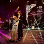 Louise Brealey Instagram – Yesterday I presented an award to my friend, the handsome and brilliant Matthew Gravelle. And End of Transmission, a show I was in with the peerless David Haig, won the two biggies – Best Writer and Best Drama – at the #bbcaudiodramaawards in the beautiful art deco Radio Theatre at Portland Place.
I can’t send this photo to my mum (who once upon a time would have printed it off on her ancient machine the size of a small car and stuck it in her scrapbook). So I’m posting it here. I don’t expect you to print it out. X
As usual all the props actually belong to my dream team @mary_fellowes (who lent me her frankly sensational velvet suit), @boredom_ily (for making it fit me), @gillsondavid (for yanking out some dreadlocks and then making my hair look like someone else’s), @nails.issys (a genius) and @lesleywhitbymakeup, who schlepped across town on a rainy Sunday night to wave her magic (mascara) wands.
PS Mary/Harri – I appear to have hoiked up my trousers too high because I was worried I was going arse over tit on the way up to present, so the requisite 1.5cm above the floor has not been observed. Soz.
#sustainablefashion BBC London