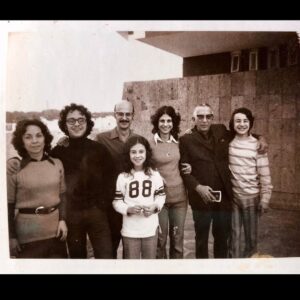 Maria Hinojosa Instagram - This foto right here is my life. Mi vida. Tampico. 1970s. Mi abuelito. My gorgeous parents. My fly sister. My cool bros. And me. I think I was trying to fit in with American kids by trying to like sports. I think this is a hockey jersey. Well, because I lived in Chicago then. Hockey, of course. My cousins from Mexico sent this last night in our chat abt our Tampico memories when about 20 of us would gather for summer or Christmas celebrations and I just wanted to share. This is the real me. 🇲🇽