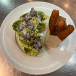 Michael Voltaggio Instagram - Caesar salad was created in Tijuana Mexico around 1924. Here’s our version almost 100 years later paired with Parmesan churros and black olive crouton for retro by voltaggio @mandalaybay