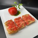 Michael Voltaggio Instagram - our mozzarella ovaline dipped in pomodoro skin is back for its final iteration at retro by Voltaggio @mandalaybay this time with a pan con tomate paying tribute to our time cooking with a true mentor @chefjoseandres