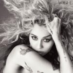 Miley Cyrus Instagram - Her addictive comeback single, “Flowers”, has kept @MileyCyrus at the top of the charts for months now – on both sides of the pond. Released in January, at this point its staying power is so remarkable it seems in danger of becoming the song of the summer. As for the easter eggs her fans insist the epic video contains? “I never need to be a master at the craft of tricking an audience,” says Miley in the June 2023 issue of @BritishVogue. “It will set itself on fire all by itself.” Click the link in bio to read the interview, and see the full story in the new issue, on newsstands Tuesday 23 May. #MileyCyrus wears all @Chopard, photographed by @StevenMeiselOfficial and styled by @Edward_Enninful, with hair by @GuidoPalau, make-up by @PatMcGrathReal, nails by @JinSoonChoi, entertainment director-at-large @JillDemling and production by @ProdN_ArtAndCommerce. [Image description: Image is a black and white close-up of Miley Cyrus’s face. Miley, a white woman, has her right hand pushed into her blonde hair, which is styled in a wavy bouffant. She is wearing a Chopard ring.]