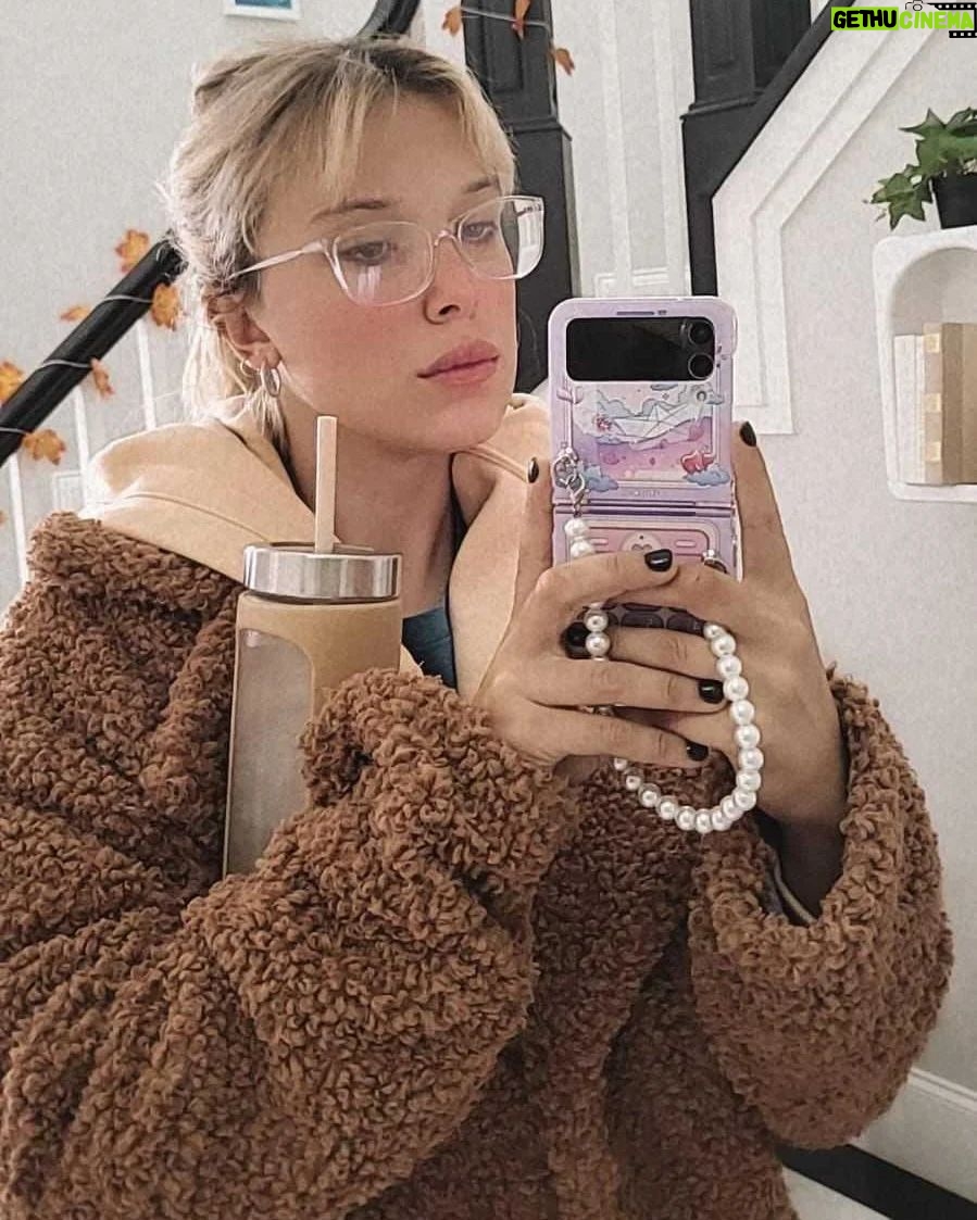 Millie Bobby Brown Instagram - bundled up in my new coat by @florencebymills x @aboutyou...coming soon! don't forget the collection is available worldwide for a few more days! 🤎🧸