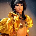 Miss Abby OMG Instagram - She’s a golden doll!🌅🕌🛖 Some people will hate you simply because they see you enjoying the success they don’t have from the work they haven’t done…🤭🌅 Pic: @cyrieljacobs @stunnin.mag Hair: @gayamua @thedragsalon #dontbejelly #befierce #goldengirl #blackhair #cleopatra #braziliangirl #tattoos #rhinestones #Drag #dragraceholland #missabbyomg #abbyomg The Golden City