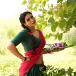 Nandini Rai Instagram – Captivating #colors and timeless elegance come #together in this stunning #image of a #woman in a vibrant #green and red sari, gracefully holding a delicate flower. The #rich #cultural heritage and #natural #beauty are #beautifully captured in this moment of serene and captivating harmony.