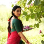 Nandini Rai Instagram – Captivating #colors and timeless elegance come #together in this stunning #image of a #woman in a vibrant #green and red sari, gracefully holding a delicate flower. The #rich #cultural heritage and #natural #beauty are #beautifully captured in this moment of serene and captivating harmony.