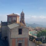 Noël Wells Instagram - ugh I went to Italy. It was so beautiful I have been in a pretty distraught since landing back in the states. There are barely any advertisements, people care about energy conservation, no one was really on their phones, everyone was chill (though on controversial note, food was just ok but to be fair I am not a food driven person.) we wandered into medieval towns I truly had no idea could possibly exist, I fucking drove a boat of a car in these medieval towns I deserve an award. I felt pretty humbled in the face of what humans have been compelled to create (mostly for god, ain't so bad to believe!). I stood at the top of a tower da Vinci drew from and what else? All the churches! I mean was I a nun in a past life?! At a certain point I realized some of the most beautiful things already exist so I could take a lot of pressure off myself and just be dumb and happy to witness life, though of course I do want to make some pretty things of my own. Also do I make a zine of this trip would you want it I have hundreds of photos! All pics of me by Gabi!