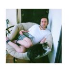 Noël Wells Instagram - just wanna get this out while I have my wits about me, but sadly today me and flinty had to put Mr. Feeny to sleep. To those who knew him, you know this is an end of a freaking era and I'm absolutely beside myself with sadness. 17 years. He was a cool fucking cat, who traversed many college adventures, apartments, houses, boyfriends, and eventually traveled 2000 miles to Los Angeles California where he settled underneath the Hollywood sign, calling Beachwood Canyon home. He was a soulmate and companion through many episodes of my youthful immaturity, but was very much loved and quite an honored and illustrious feline who would take walks around the neighborhood and played fetch. He made many brushes with death, but many more brushes with notoriety, landing himself in a viral zine (How to Talk To Your Cat About Gun Safety) being featured in a a published book (Cat Lady, curated by Leah Goren) and of course, he was the inspiration and basis for my first feature film "Mr. Roosevelt." We were lucky to be there with him in his final moments, and he was in my arms with his pretty white paws resting on my wrists like he used to when he was a lil one. Thank you so much Flint for being a good cat dad, and thank you Dave for everything. Thanks to all my friends who knew and got him. For just a fucking cat he was one of the very greats.