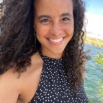 Parisa Fitz-Henley Instagram - Oh my goodness I’m so grateful! The last week and a half since my birthday (22 July) has been so rich. I spent the day itself driving through the desert on a solo cross country journey. This was my second birthday in a row in the desert, a place this water baby has come to appreciate so deeply. Following the example of friends who claim an entire month to celebrate their own births I decided to just stay open, navigating the habitual awkwardness I’ve had around celebrating mine at all. I decided to receive, to associate this time with an extra openness to joy and discovery — and what do you know, they showed up! 🤩 This is me in hot hot hot Nevada, in front of the ice-cold, beautiful Colorado river, with Arizona on the other side. I soooo recommend driving across a country — especially if you could use a reminder of the vastness of this planet, that in Truth we belong to all of it and that it belongs to all of us. I didn’t forget the lines that have been drawn, or the mindfulness required to navigate our many misunderstandings and shortcomings. I just got a chance to remember the bigger stuff more. What a blessing!!! Many thanks to all who sent messages last week. I wish I could have responded to them all individually. Please know how much they and you have been appreciated. I’m learning it’s always a good time to receive. It’s always the right time to feel joy. Nature is the definition of generosity and a reminder of our place in existence. There’s beauty even in dry expanses. Spirit is the ever-present, constant companion. It’s possible to not only step into the future with open arms, but also to gain new understandings of the past with an open heart. And of course, that magic abounds. Here’s to another year of life! Thank you for being a part of mine! Image description: A selfie of me smiling, curly brown hair out and blowing in the breeze, wearing a black halter top with white polka dots. Behind me, the green-blue Colorado River rippling, a bit of green foliage, white sand and a blue sky with whisky white clouds.