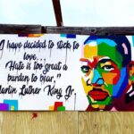 Parisa Fitz-Henley Instagram - “I have decided to stick to love… Hate is too great a burden to bear.” — Martin Luther King 💙💚🤎💛🤍🧡🖤❤️💜 Image: Multicolor painting of MLK on an outdoor wooden wall w/the above quote.