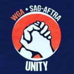 Parisa Fitz-Henley Instagram - I stand with @sagaftra @wgaeast @wgawest. May this unified strike swiftly bring justice to our unions and beyond. #SagAftraStrong #SagAftraStrike Image description: Sign with a blue background. On it in white, “SAG-AFTRA” “Unity” and two hands clasped on an orange background. In orange lettering “WGA.”