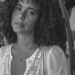 Parisa Fitz-Henley Instagram - More LA memories. Exploring shadow and light with @raziwilsonphotography 🤍🖤🩶 Post description: Three slides - black and white photos of me. A close up of me looking to camera, a medium shot of me walking, and a medium shot of me leaning back on a wall. In all I wear the same white dress and my hair is curly and shoulder length. *Reposting correct edits