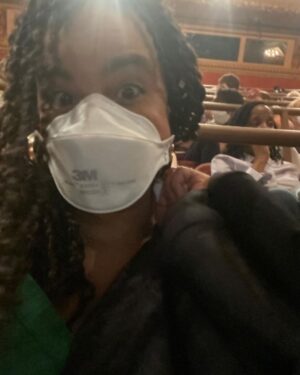Parisa Fitz-Henley Instagram - #FatHam on Broadway with one of my besties. 🎭 🥰 This is the last week so if you’re in NY grab tix! Front and center of the mezzanine is fantastic! 

Slide 1: Me smiling, my hair in twists, wearing a white N95 respirator, gold earrings and a black blazer. I’m standing in front of the words “Fat Ham” in glitter on a wall. 

Slide 2: Me smiling, same place and time but with my friend Aeric (also smiling), who has brown skin and is wearing a silver necklace and thick black hair wrap/band. 

Slide 3: A selfie of me in my seat in the theater